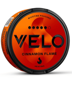 Round red-orange can of VELO Cinnamon Flame with 10MG nicotine strength on green grass background.